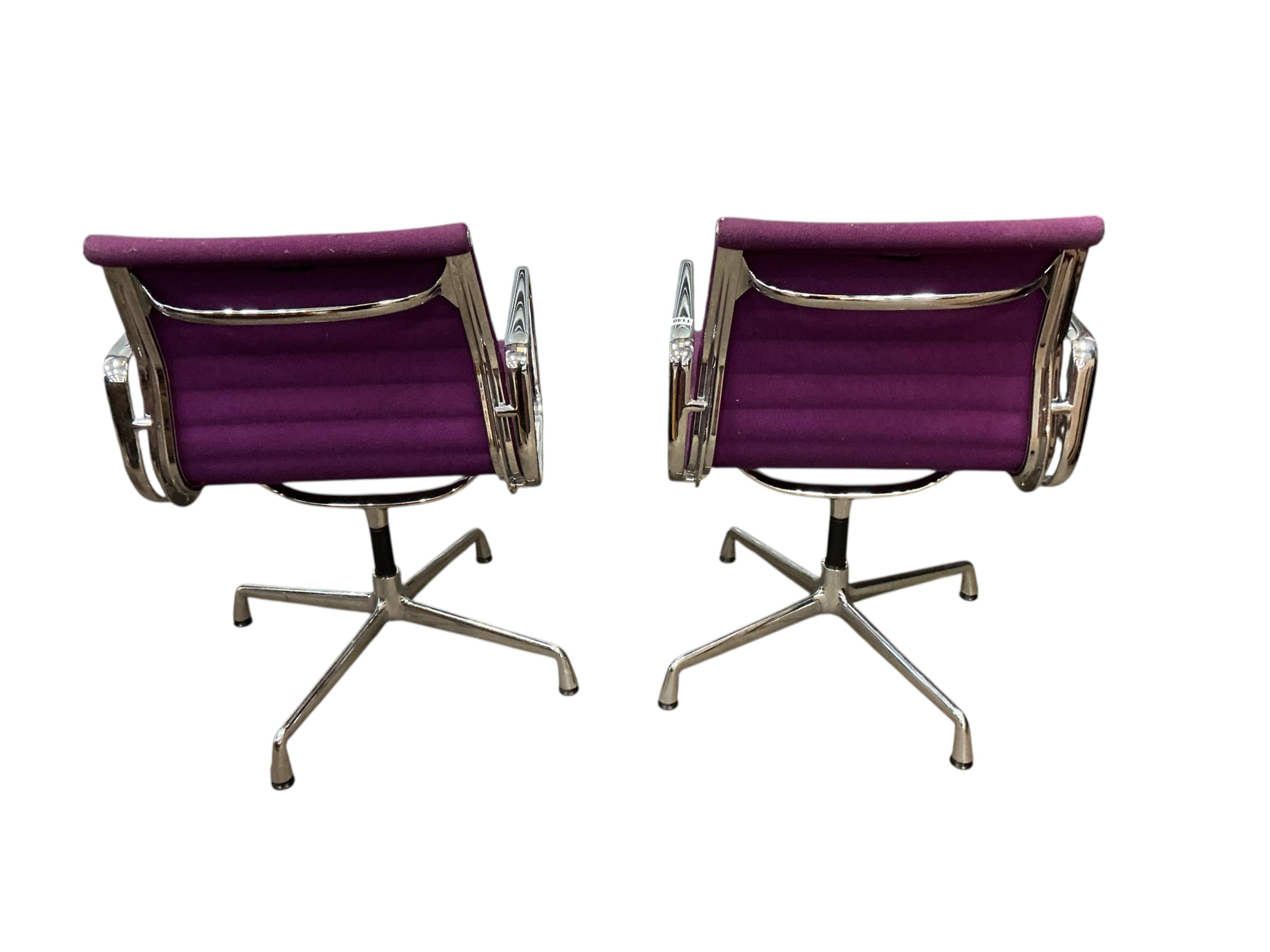 Charles Eames for Vitra, a pair of chrome swivel desk chairs on four prong bases, width 57cm, depth 50cm, height 82cm